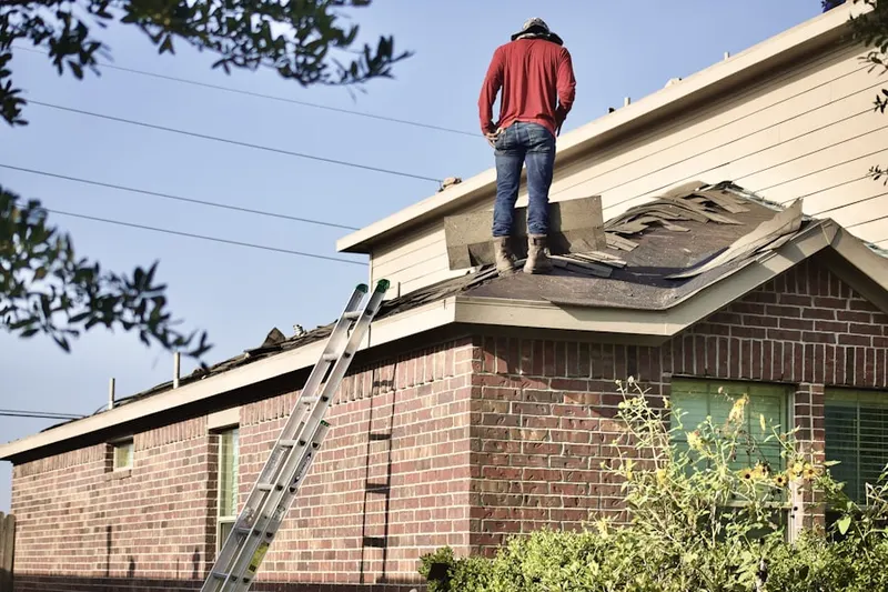 Professional roofer working on a residential roof in Fruitland